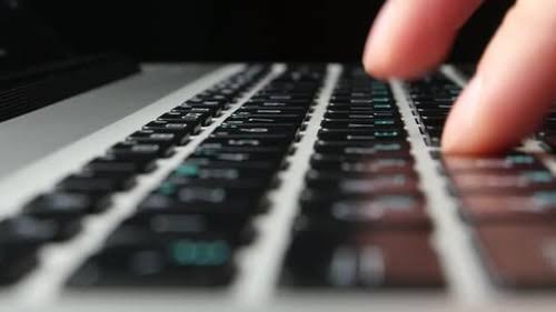hands typing on keyboard